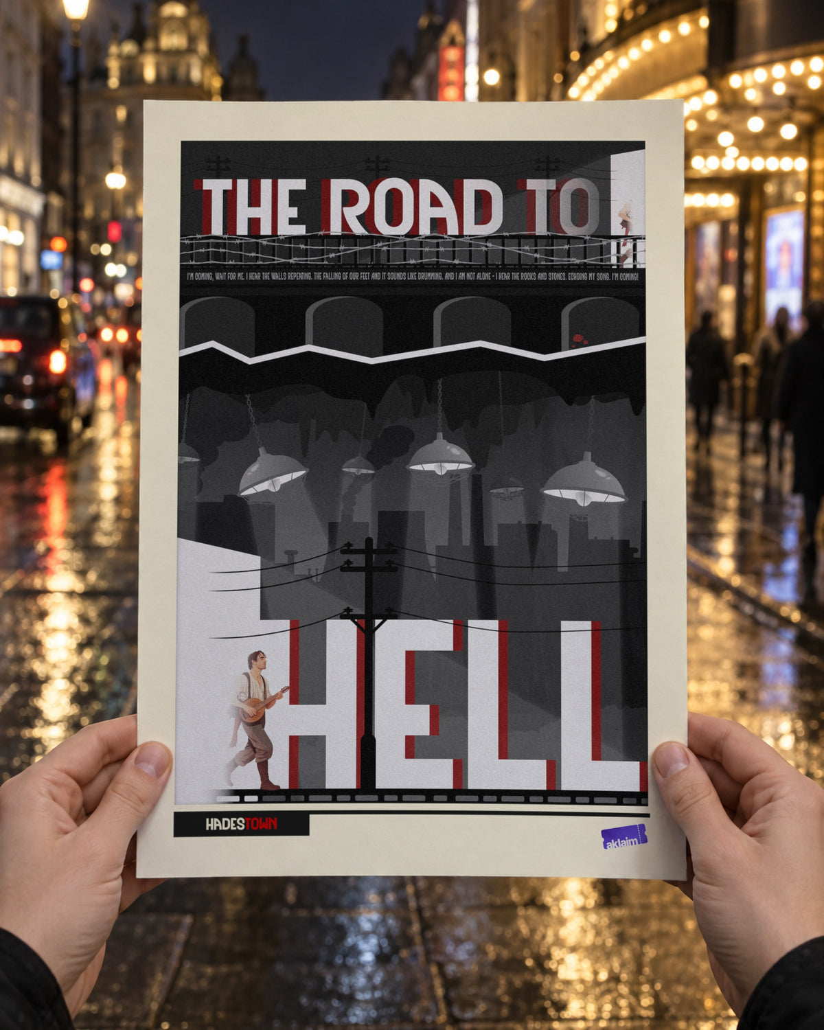 The Road To Hell Hadestown poster held up in two hands on a rain-wet West End street at night