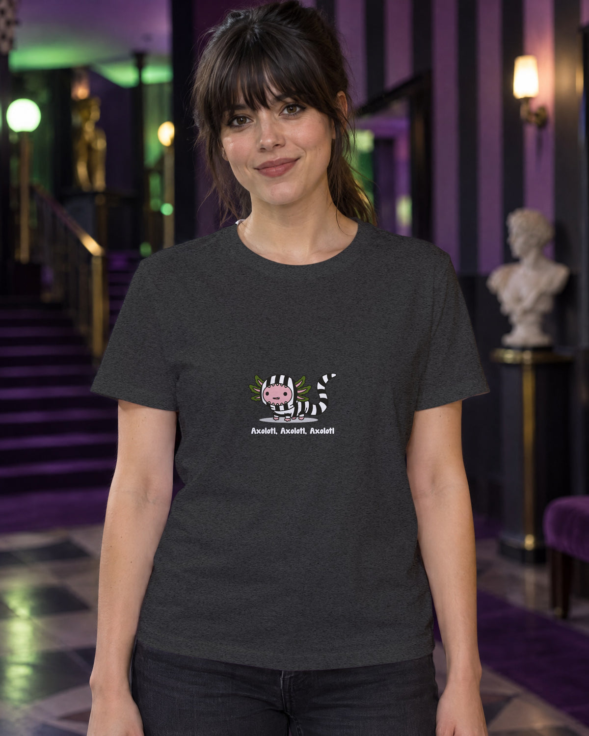 Axolotl Beetlejuice t-shirt in Dark Heather Grey, worn in a black-and-purple striped theatre foyer