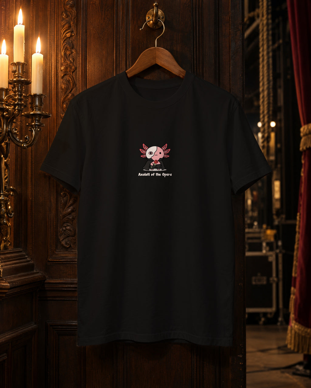 Axolotl of the Opera t-shirt in Black on a hanger in a candlelit backstage corridor
