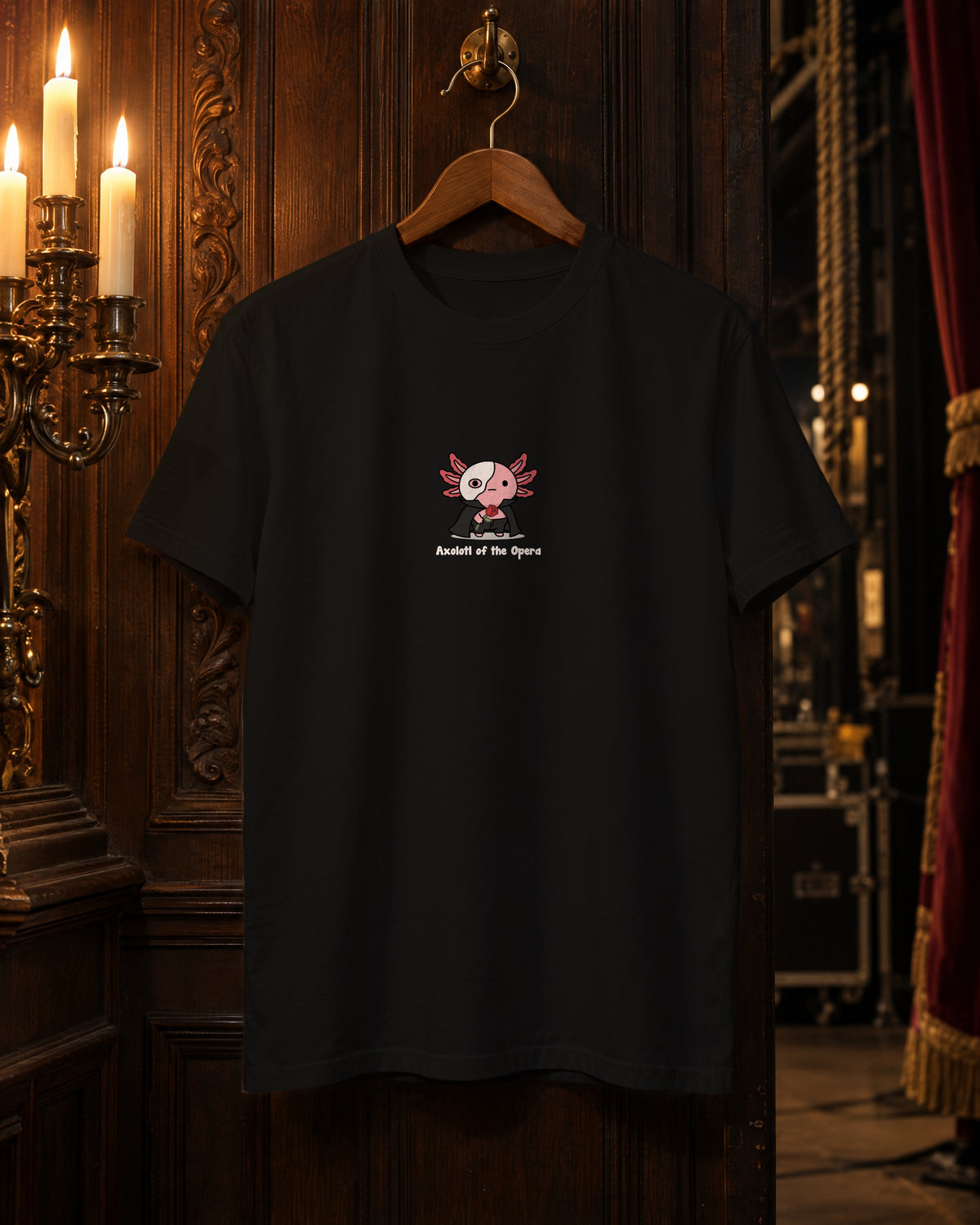 Axolotl of the Opera t-shirt in Black on a hanger in a candlelit backstage corridor