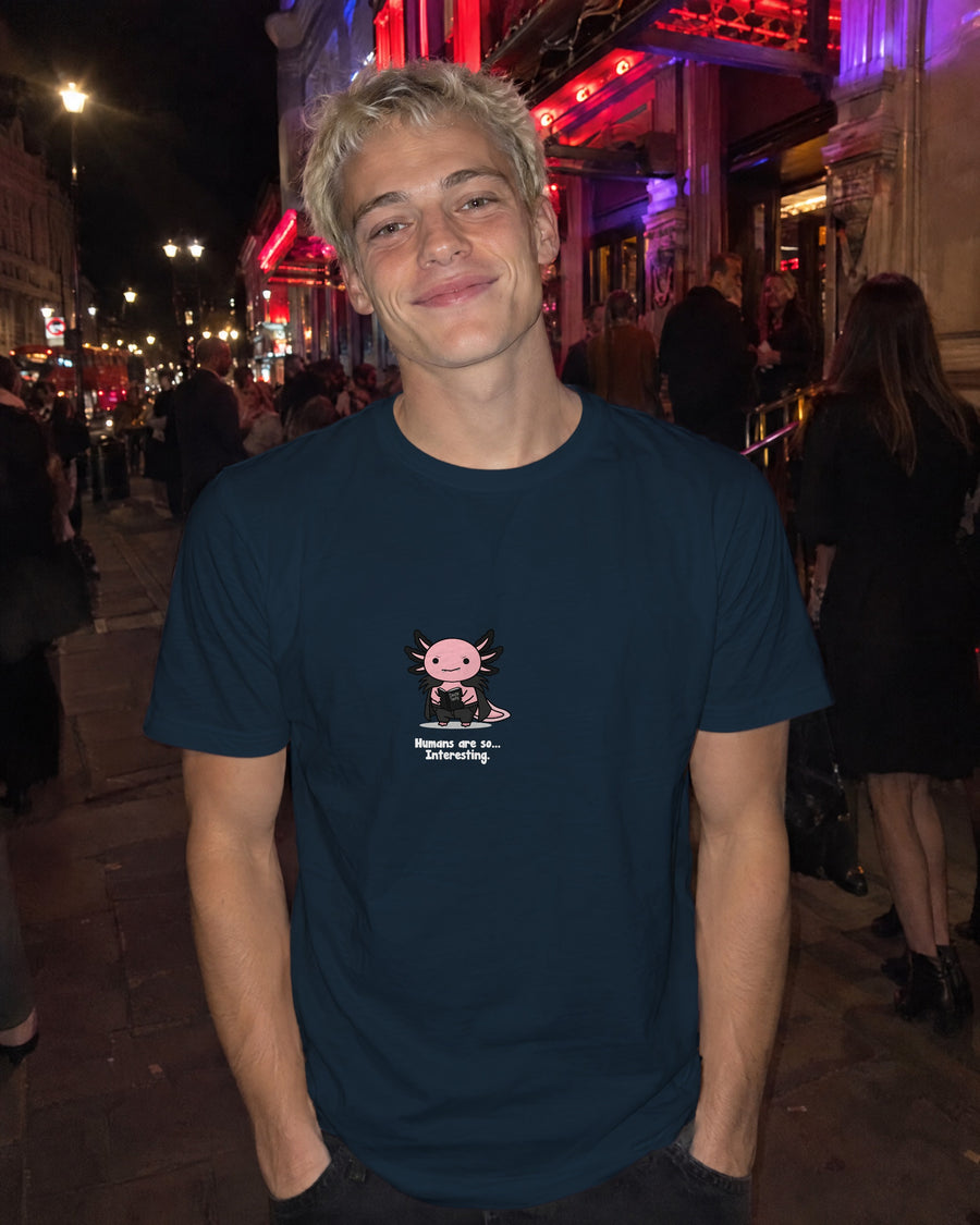 Humans Are So Interesting t-shirt in French Navy, worn on a street outside a theatre at night